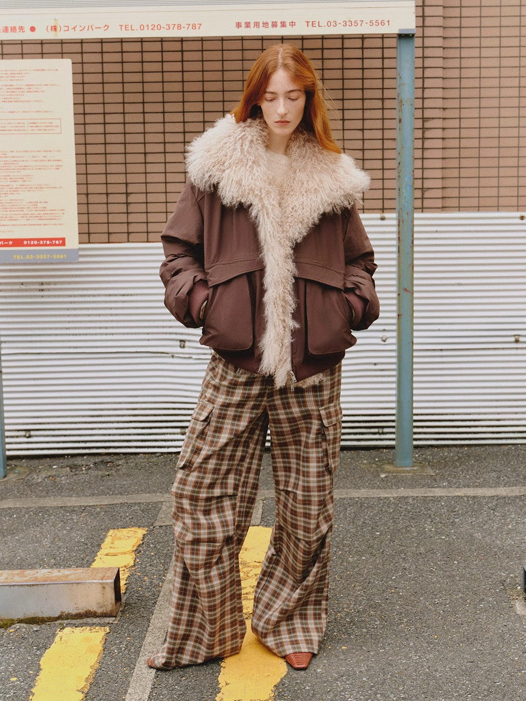 "Winter Is Coming" brown down parka with wool collar worn open, outdoor street shot