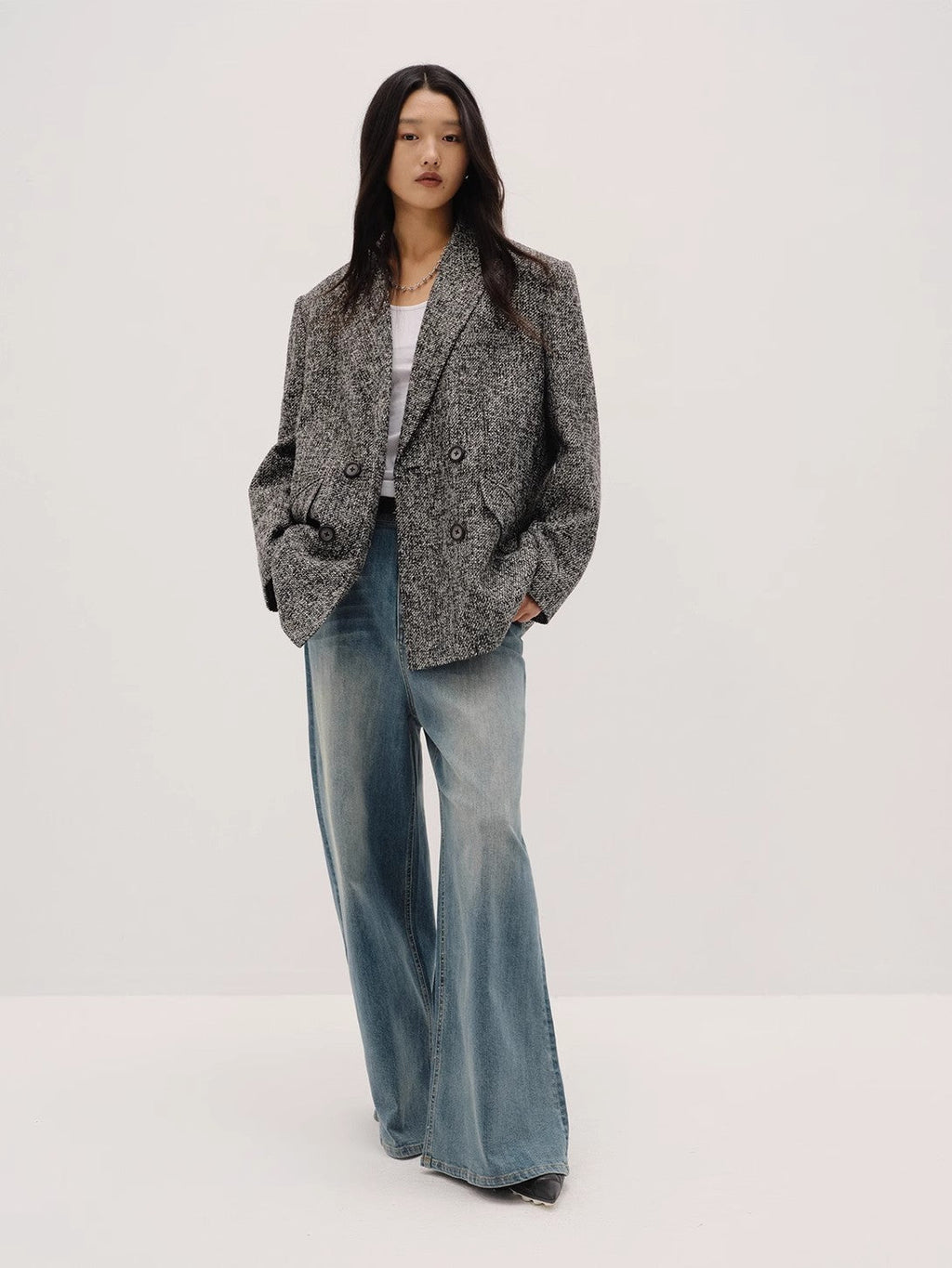 "Long Night Meteor" gray herringbone Italian tweed blazer, oversized double-breasted fit, styled with wide-leg jeans — front view