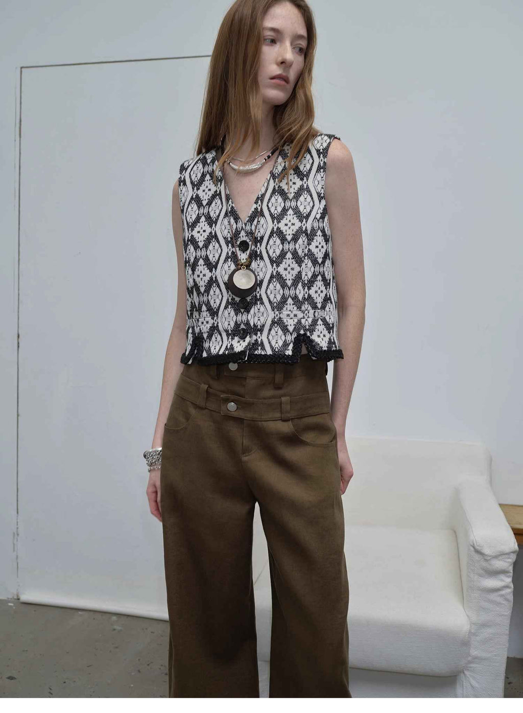 "Venice" black and white jacquard V-neck vest, studio portrait