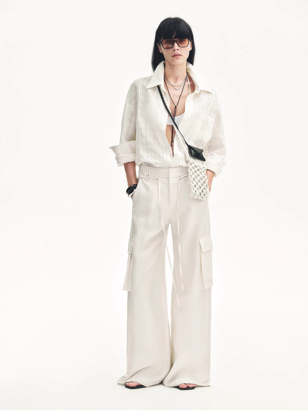 "Rhythm in the Same Frequency" white Tencel linen wide-leg cargo pants styled with a matching white shirt and crossbody bag, full-length front view