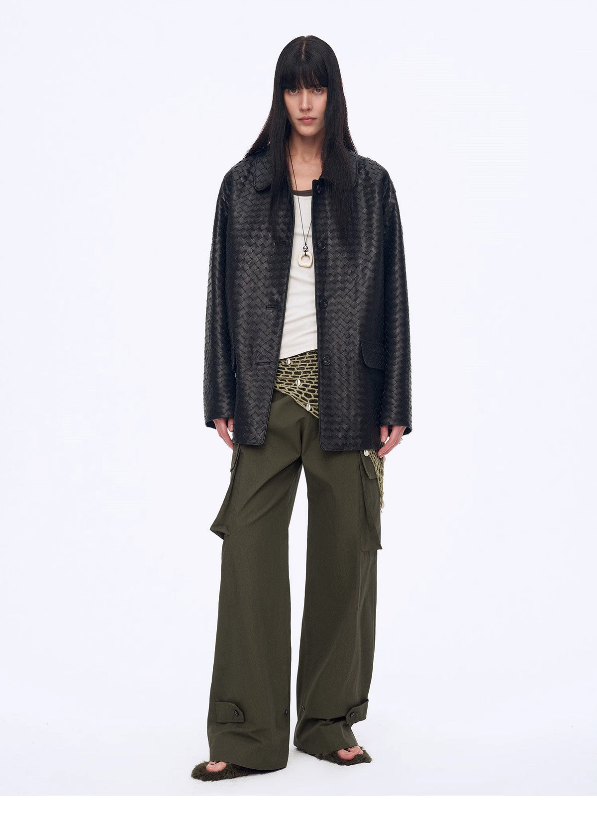 "Rembrandt Night" black perforated lambskin woven leather jacket with olive cargo pants, full-length front view