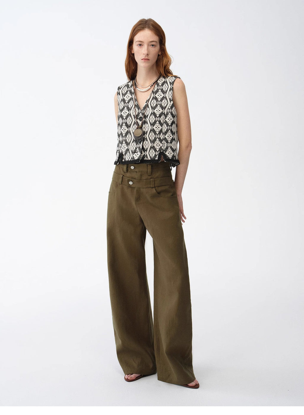 "Venice" Italian jacquard V-neck vest in black and white with olive trousers, front view