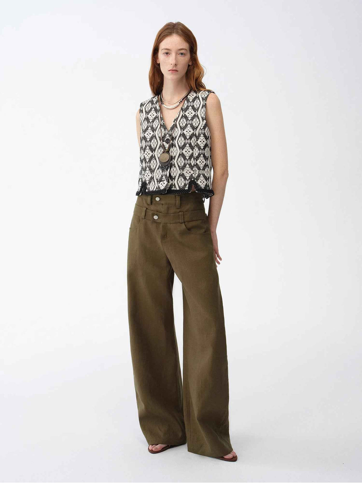 "Venice" Italian jacquard V-neck vest in black and white with olive trousers, front view
