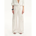 Close-up of the Rhythm in the Same Frequency white wide-leg pants showing the side cargo pocket and drapey linen fabric
