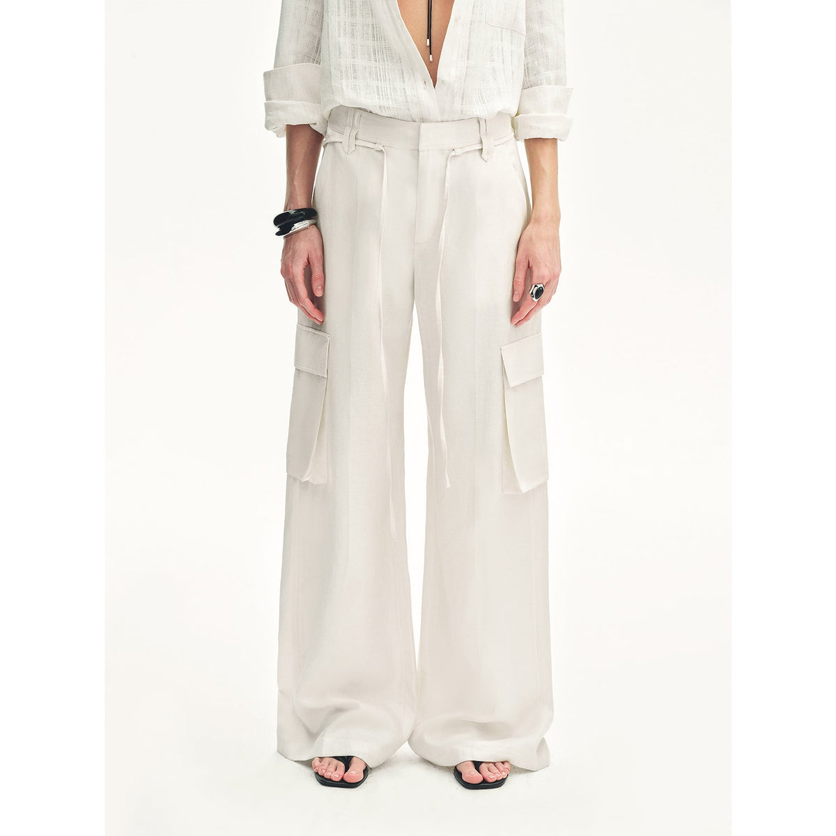 Close-up of the Rhythm in the Same Frequency white wide-leg pants showing the side cargo pocket and drapey linen fabric