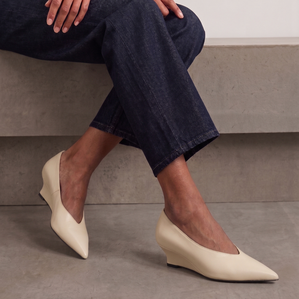 JoJo Leather Wedge Pumps in bone — styled on model